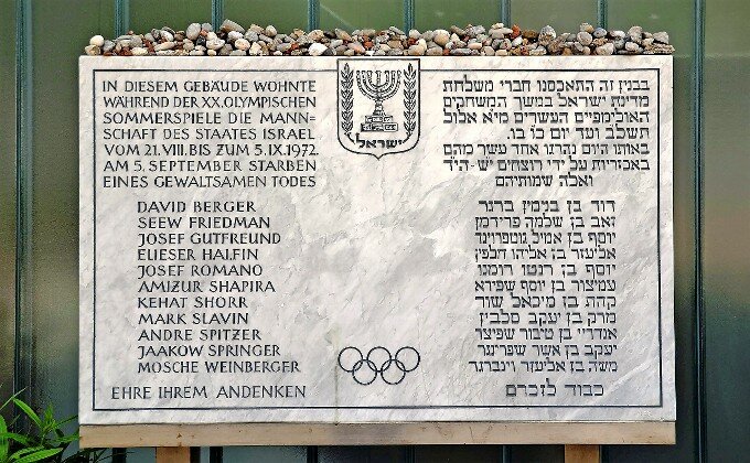 A plaque in front of the Israeli athletes&rsquo; quarters commemorates victims of the 1972 Munich Olympics massacre. The inscription, in German and Hebrew, reads: &ldquo;The team of the State of Israel lived in this building during the 20th Olympic Summer Games from 21 August to 5 September 1972. On 5 September, [list of victims] died a violent death. Honor to their memory.&rdquo;