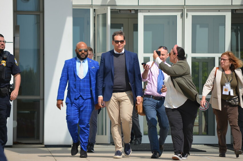 Rep. George Santos walks out of the courthouse in Central Islip on Wednesday after pleading not guilty to multiple federal charges including wire fraud and money laundering.