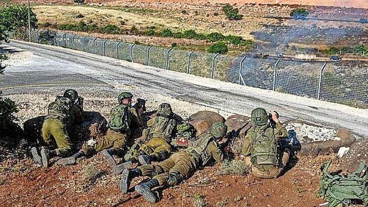 Israeli soldiers guard in Metula, in Israel on the border with Lebanon, on May 14, 2021, after Lebanese protesters crossed the border fence earlier in the day.