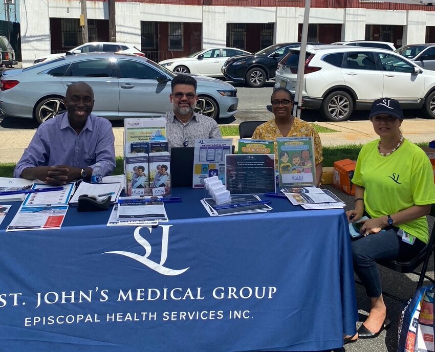 Jean Desrosiers, left, Camillo Villarreal, Joselin Lajara and Rosemary Alerte represent St. John's medical distributing health information and appointment scheduling assistance to community members.