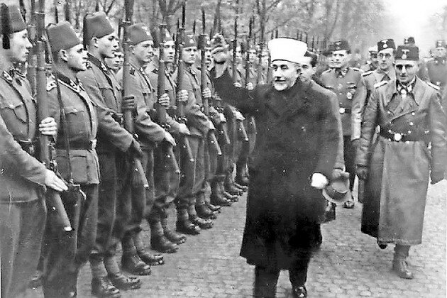The Grand Mufti of Jerusalem Amin al-Husseini salutes the Bosnian Waffen SS in November 1943.