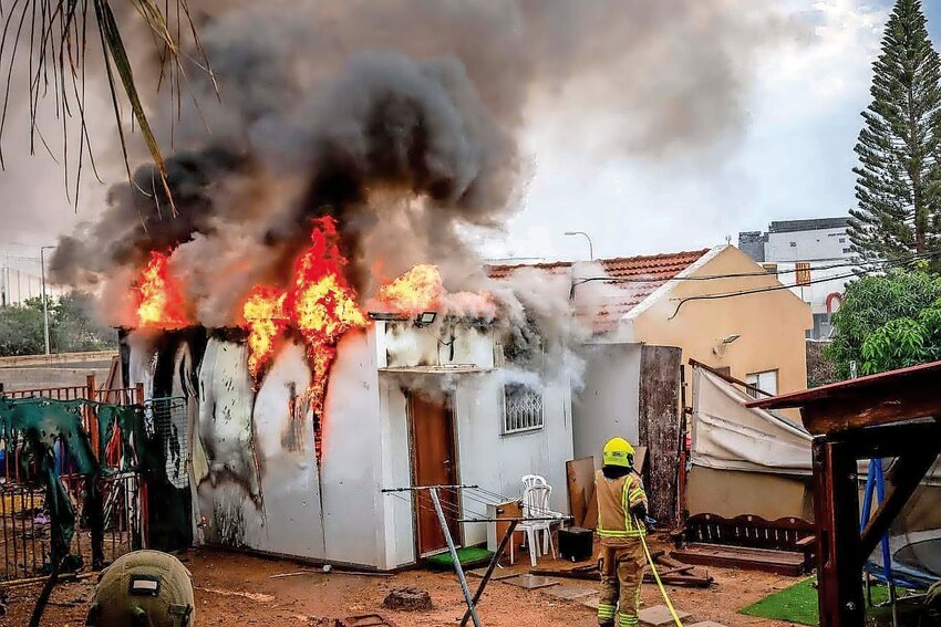 House on fire: Israeli security forces at the scene where a rocket fired from the Gaza Strip hit a shelter in the southern Israeli city of Sderot on Oct. 9. With Israel at war, explains Jonathan Tobin, the Jewish consciousness of today&rsquo;s American Jews is on trial.
