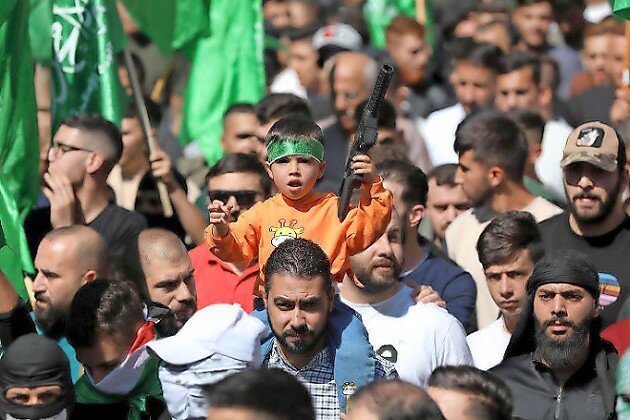Palestinians march during a pro-Hamas protest in Hebron on Oct. 13.