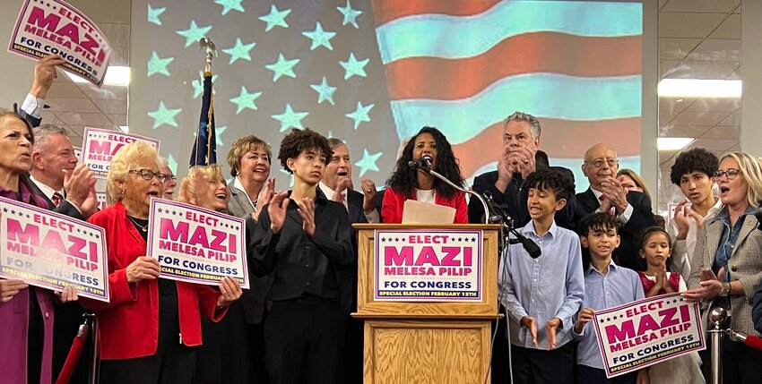 Mazi Melesa Pilip, flanked by five of her seven children and Long Island Republican leaders &mdash; including (in photo) county GOP chairman Joseph Cairo, Hempstead Town Supervisor Kate Murray, former Rep. Peter King and former US Senator Al D'Amato &mdash; accepts the Republican nomination to Congress, at the American Legion Hall in Massapequa on Friday.