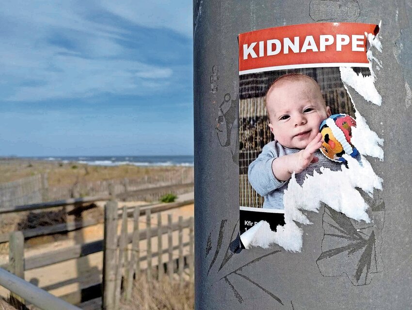 A half-ripped poster seen in Ventnor, NJ, on April 28, of Kfir Bibas, an Israeli child abducted to Gaza with his brother and parents on Oct. 7.