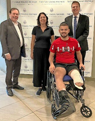 Jonathan Benhamou is flanked by Ben Landa, owner of the Five Towns Premier Nursing and Rehabilitation Center in Woodmere; Ellen Benhamou, Jonathan&rsquo;s mother, and center Administrator Joseph Benden.