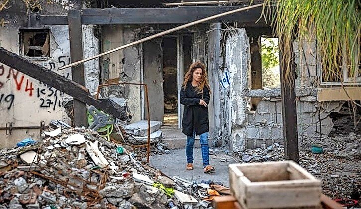 A woman amid the ruins of Kibbutz Be&rsquo;eri after Hamas terrorists attacked, Dec. 20, 2023.