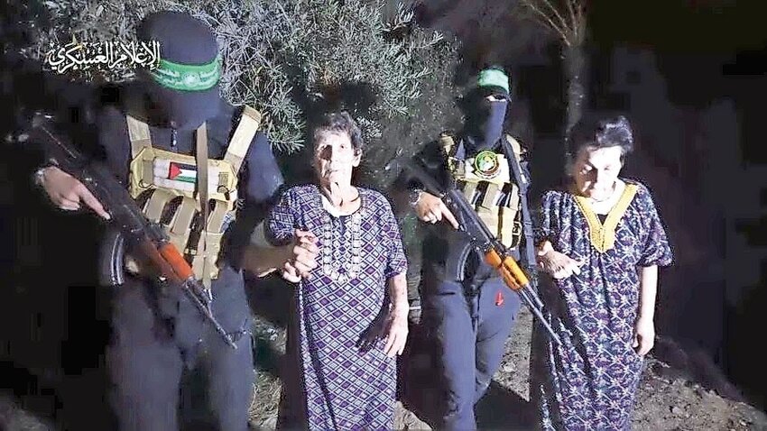 Nurit Cooper, 79, and Yocheved Lifshitz, 85, with Hamas terrorists before their &ldquo;humanitarian&rdquo; release on Oct. 23, 2023.