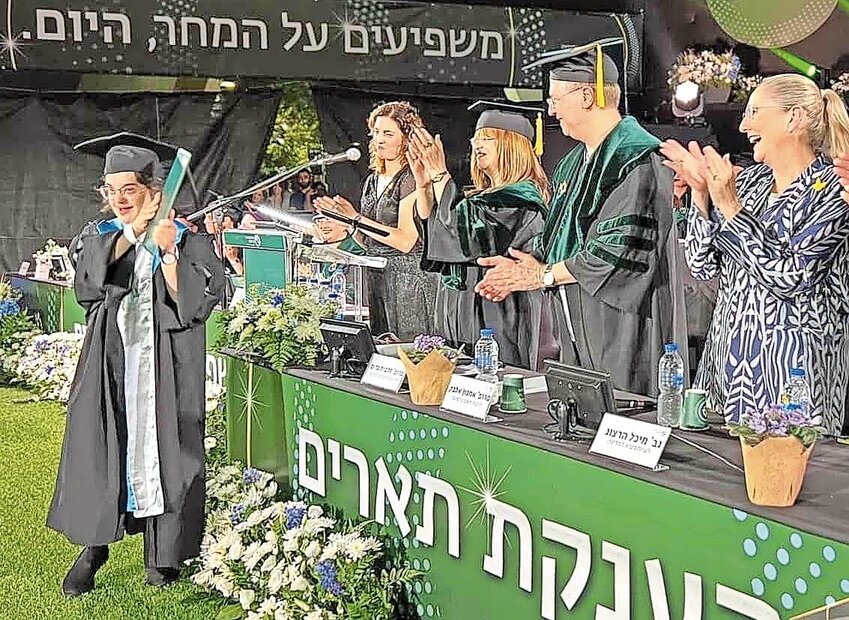 Israeli first lady Michal Herzog congratulates a graduate at ceremony in Ramat Gan on July 10.