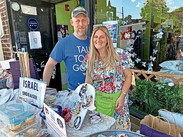 Jeremy and Cindy Merrill, owners of Dimples, a custom baby gift store, have been participating in the sidewalk sale for 18 years.