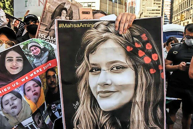 A protester holds a picture of Mahsa Amini, the Kurdish-Iranian woman whose 2022 death in the custody of Iran&rsquo;s &ldquo;morality police&rdquo; sparked widespread unrest in the Islamic Republic.