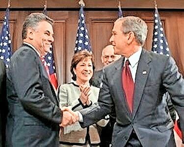 President George W. Bush shakes hands with Rep. Peter King, chairman of the Homeland Security Committee, after signing the SAFE Port Act on Oct. 13, 2006.&nbsp;