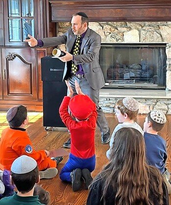 Chaim Gitelis performing at the Chai Lifeline Purim Party in the Five Towns.