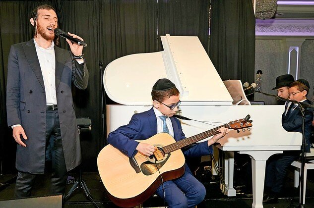 Shulem Lemmer was accompanied by three of Rabbi Shay and Rebbetzin Rina Schachter&rsquo;s children, as he performed during last week&rsquo;s dinner marking the Young Israel of Woodmere&rsquo;s 64th anniversary, at Marina Del Rey in Throgs Neck.