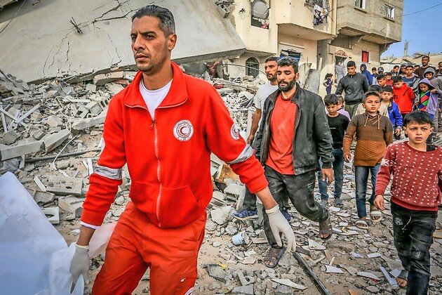 Palestinians and Red Crescent crews in the Gaza Strip retrieve bodies from the rubble of the Abdul Hadi family home after an Israeli airstrike that killed 11 people on April 6.