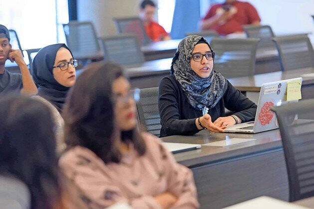Students participate in a seminar-style class at Northwestern U in Qatar in 2017.