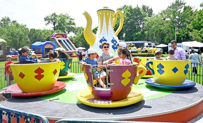 Kids enjoyed spinning in the Tea Cups at the 25th annual Kulanu Academy fair.