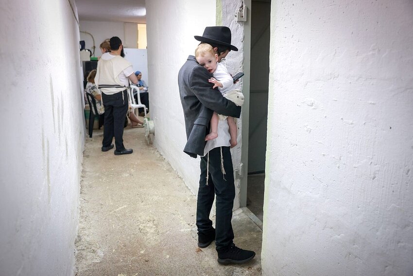Tefilah and Torah in a public shelter in northern Israel during alarms and rocket and missile fire from Iran, on June 15.