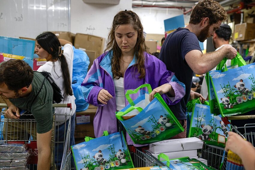 Young volunteers pack kits to distribute to young families in Jerusalem amid war between Israel and Iran, on June 15.
