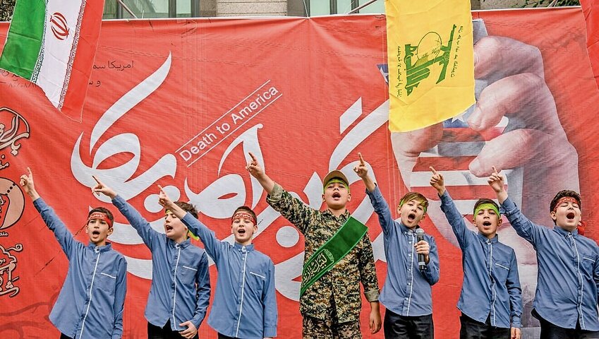 Iranian children perform on stage in front of a &ldquo;Death to America&rdquo; banner in Tehran on Nov. 3, 2024.