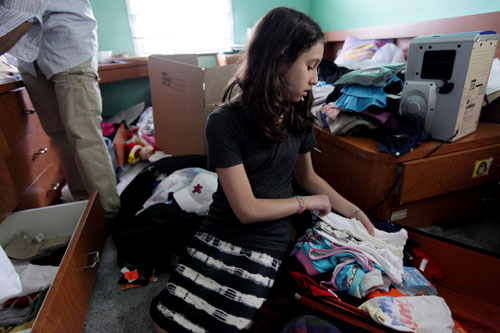Dafna Katz, 12, of North Woodmere, is pictured packing in her room, Tuesday, June 22, 2010. Katz and her family are moving to Chashmonaim in the West Bank in August.