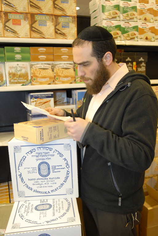 Gourmet Glatt grocery manager Shloy Rubinstein oversees the transition to Pesach merchandise.