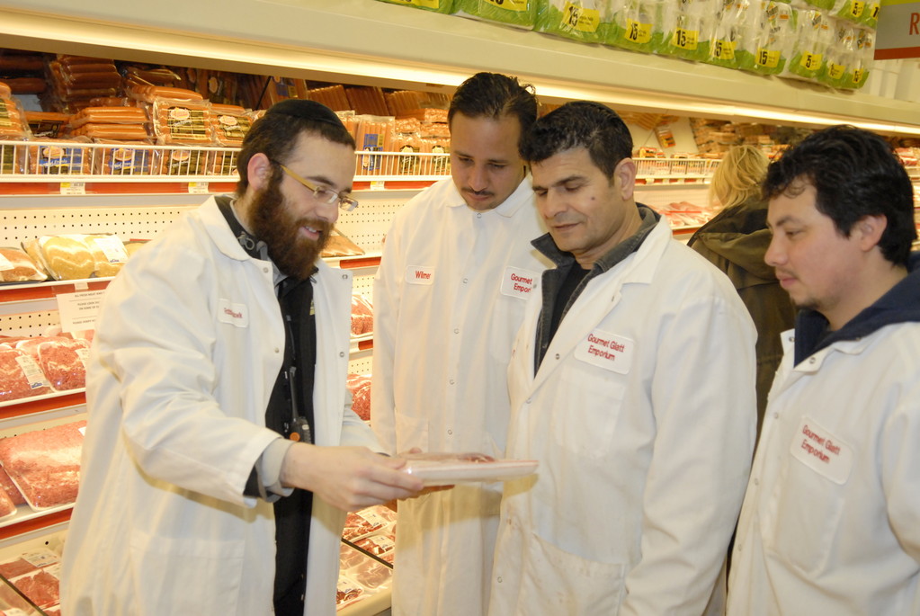 Meat manager Rabbi Berel Wolowik instructs staff.