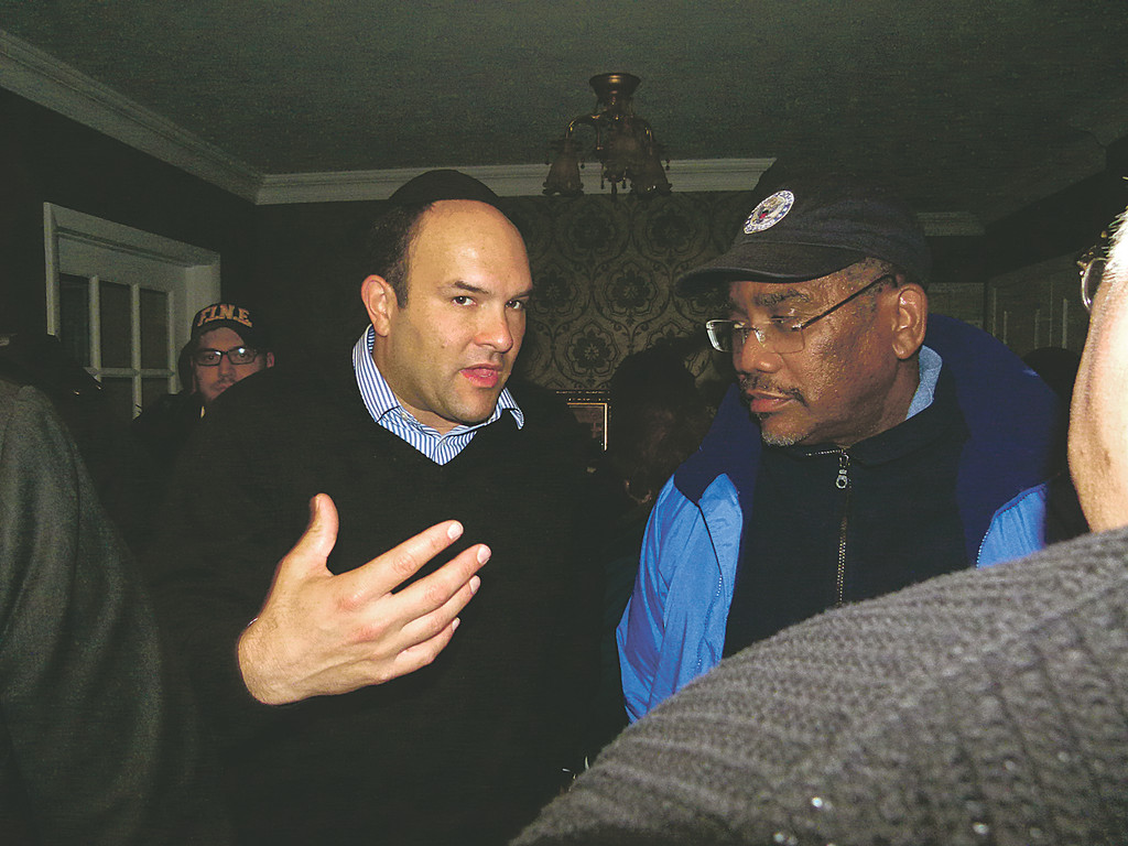 Michael Fragin discussing the damage to the community with Congressman Gregory Meeks following the aftermath of Hurricane Sandy.