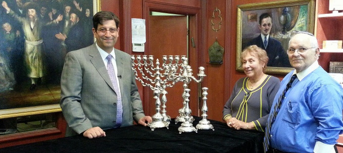 Jonathan Greenstein prepares to evaluate a family’s silver Judaica at the J. Greenstein Gallery in Cedarhurst for the filming of “Jewish Gilt,”  a Jewish “Antiques Roadshow” type of show available for viewing on The Jewish Channel.