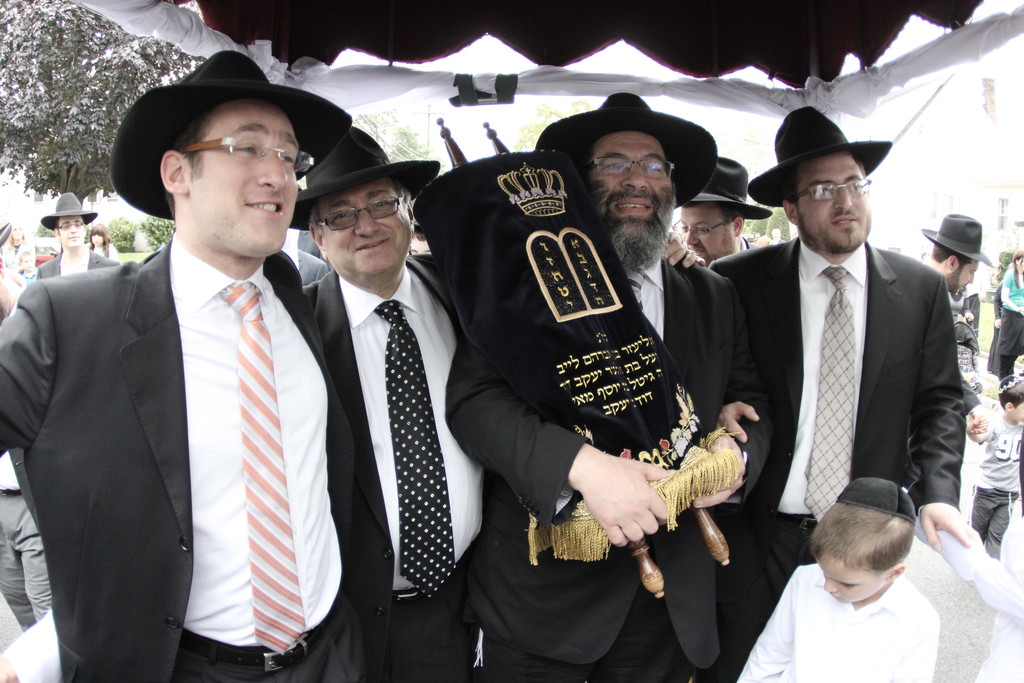 Celebrating a new Torah in Inwood (left to right): Yehuda Zachter, Mel Zachter, Rabbi Yaakov Bender and Rabbi Pinchos Weinberger, Rav of Bais Tefila of Inwood.