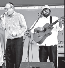 Simcha Weber with Yonatan Tzarum from Simpy Tsfat perform a song together.
