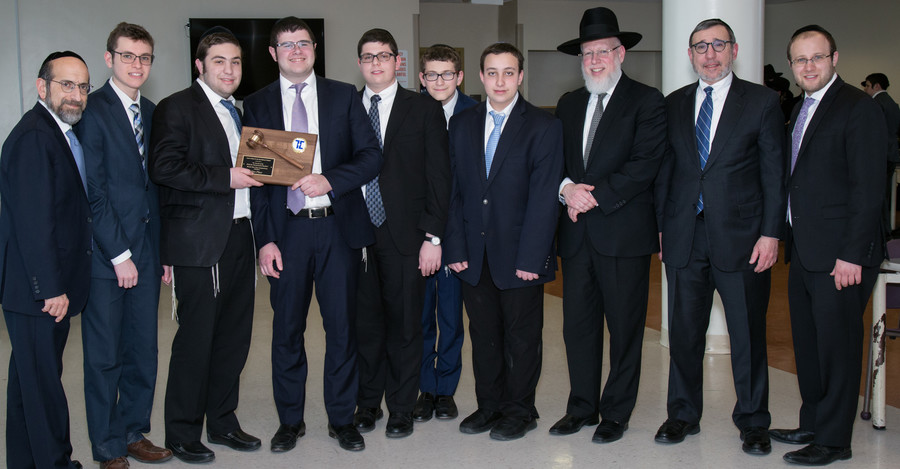 Lander College For Men Rabbi Yonason Sacks, Dean Moshe Sokol and Rabbi Aryeh Manheim congratulate the winning team.
