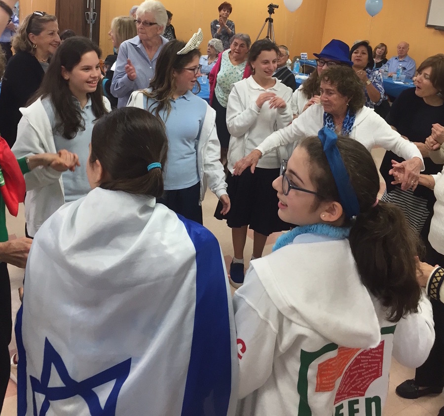 Shulamith celebrates with seniors: Eighth graders went to the Five Towns JCC for a pre-Yom HaAtzmaut celebration with local seniors. The blue-and-white clad girls bantered and danced with the seniors, and joined in a spirited rendition of “Happy Birthday” for a woman celebrating her 100th.