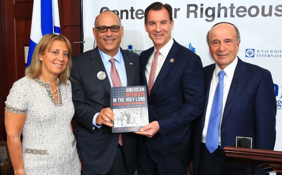 Five Towners Iris and Shalom Maidenbaum present a copy of “American Interests in the Holy Land” by Lenny Ben-David, to Rep. Tom Suozzi (D-NY) of Long Island.
