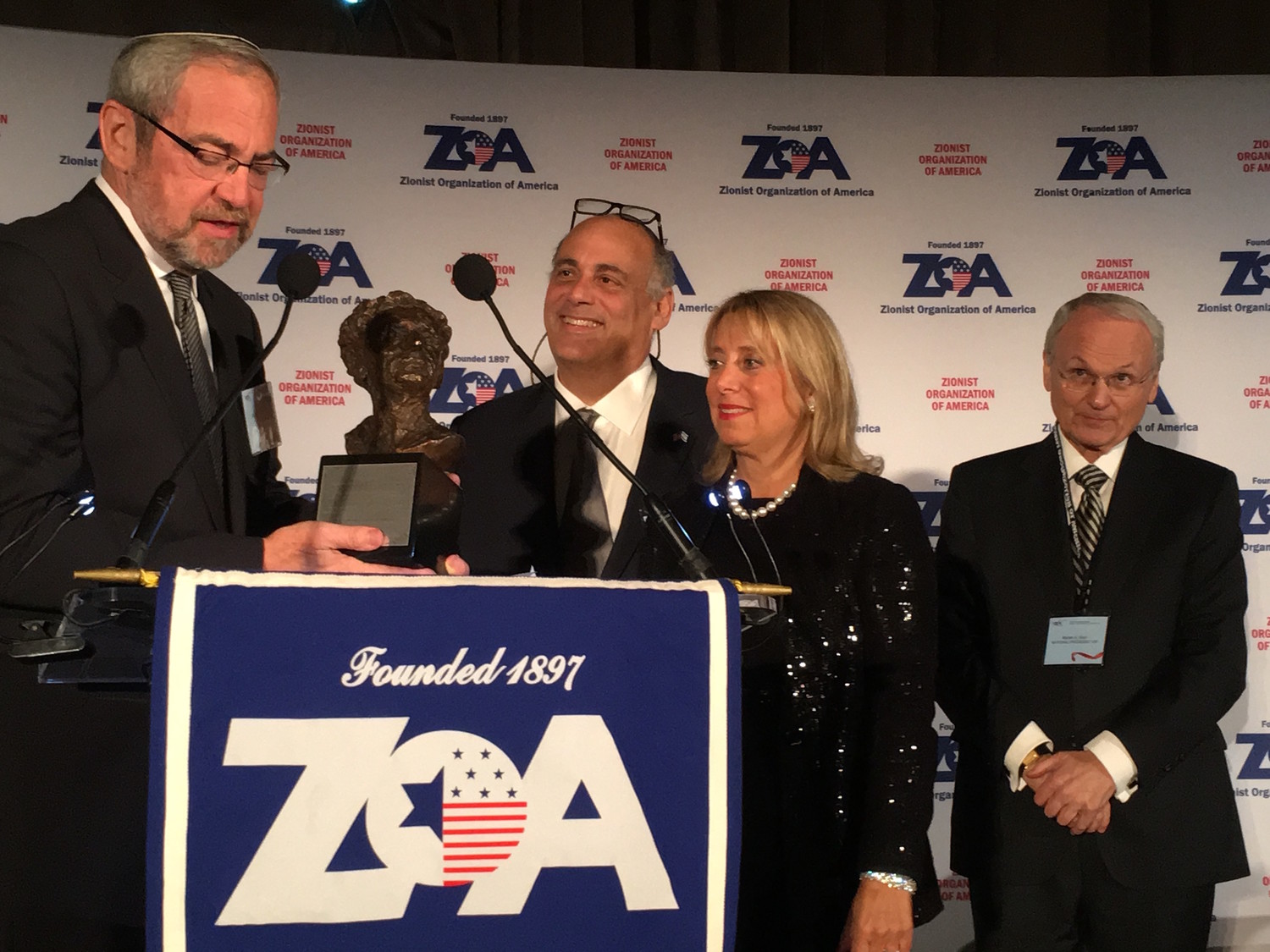 Rabbi Kenneth Hain of Congregation Beth Sholom in Lawrence presents the Louis D. Brandeis award to Shalom and Iris Maidenbaum at Sunday night’s ZOA gala, as ZOA President Morton Klein looks on.