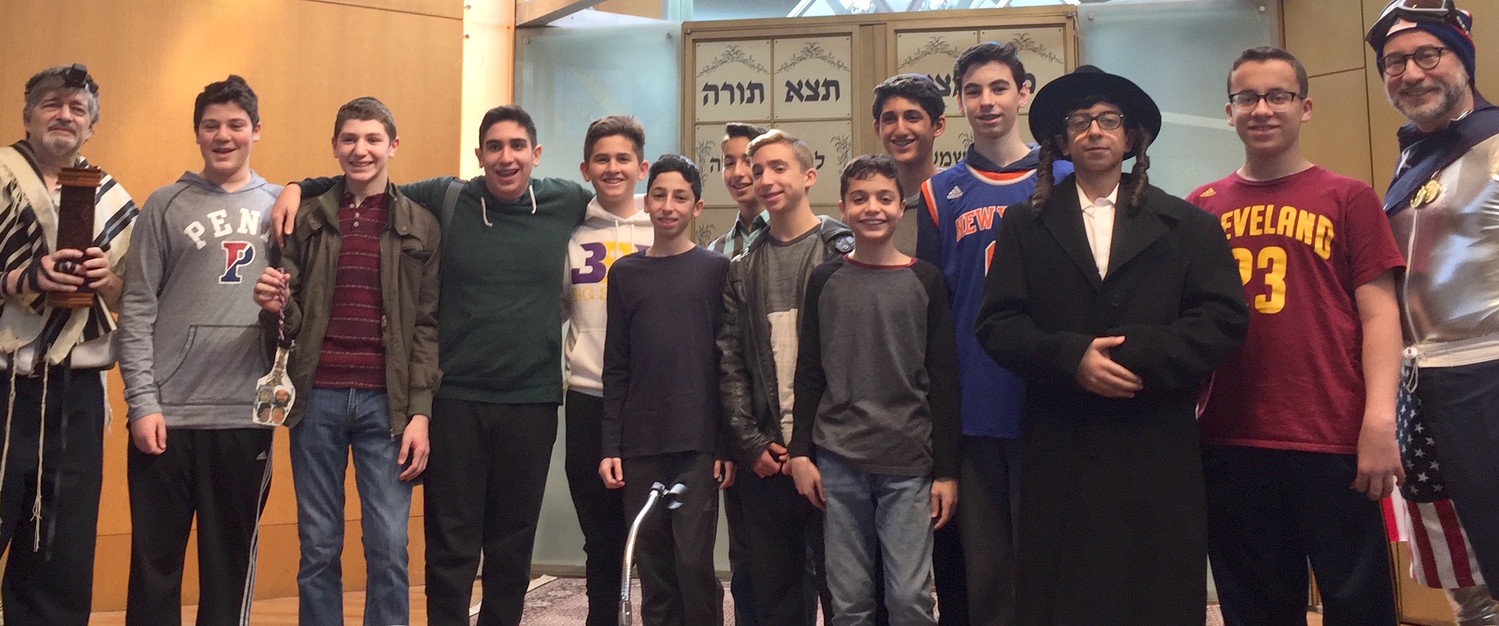 For 16 years, Dr. Paul Brody (at left) of Great Neck has instructed North Shore Hebrew Academy students in the sacred ritual of chanting the Megillah.