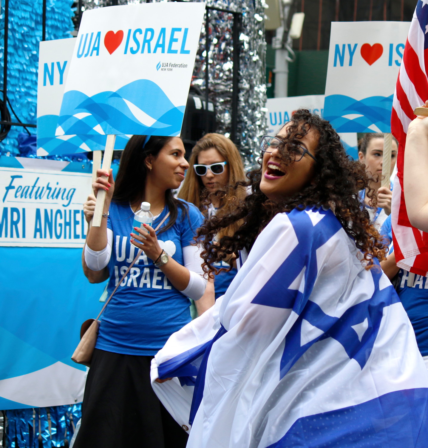 Flags fly as NY celebrates Israel: Marcher from UJA Federation New York shows her blue-and-white.