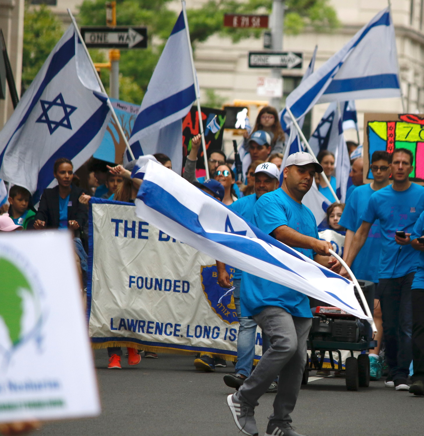 A member of the contingent from the Brandeis School in Lawrence waves Israel's flag.