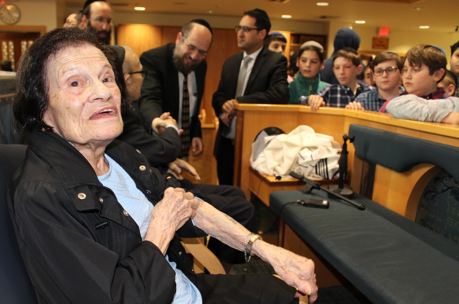 Holocaust survivor Dora Siegelman shows students at the Yeshiva of South Shore the numbers on her arm.