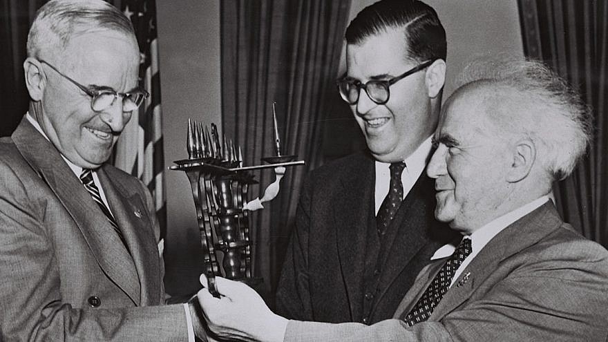 President Harry Truman accepts a menorah from Israeli Prime Minister David Ben Gurion, accompanied by Israeli Ambassador to the US Abba Evan, during Ben Gurion's visit to the United States.