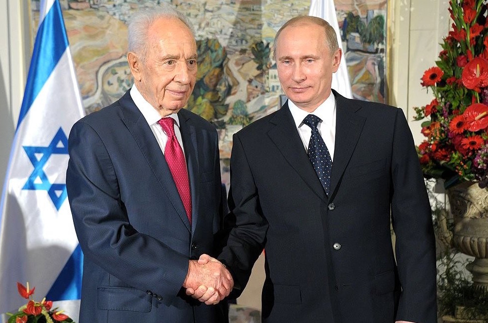 In Moscow, Russian President Vladimir Putin greets Israeli President Shimon Peres in 2012.