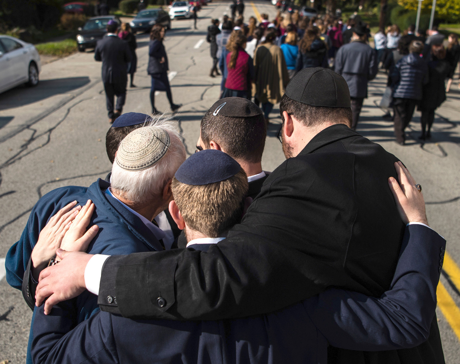Mourners embrace during outside of Congregation Beth Shalom in Pittsburgh for the funeral of Joyce Fienberg, who was killed at the mass shooting at the Tree of Life synagogue shooting on Oct. 31.