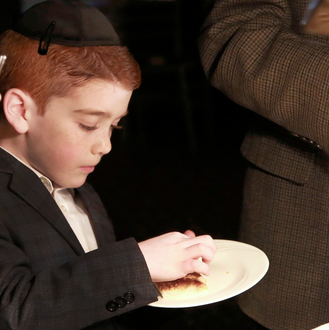 Seven-year old Levi Horshander, son of an awardee, samples focaccia bread.