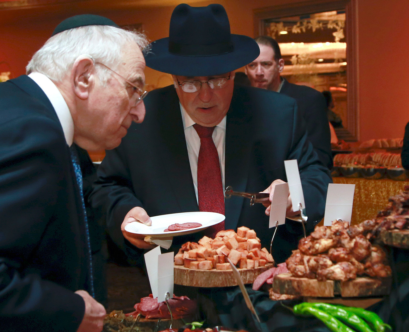 Charles Meisels and Lloyd Keilson browse the selection at the charcuterie table.