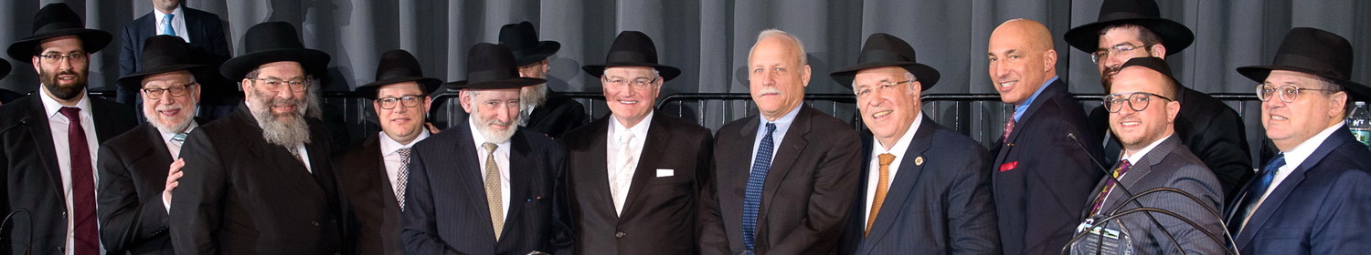 At a gala for Far Rockaway’s Yeshiva Darchei Torah, a presentation was made to individuals who were instrumental in securing the refinance of the Yeshiva’s mortgage. From left: Rabbi Avrohom Bender, Rabbi Avraham Schachner, Rabbi Yaakov Bender, Shia Ostreicher, Samuel Krieger, Ronald Lowinger, Thomas Hunter of KeyBank, Rabbi Lloyd Keilson, John Manginelli of KeyBank, Rabbi Moshe Bender, Ben Orlofsky and Yossi Gross. The dinner drew over 2,000 guests to Darchei’s Beach 17th Street campus to celebrate its “Darchei Way” — a compassionate, individualized approach to Jewish education.