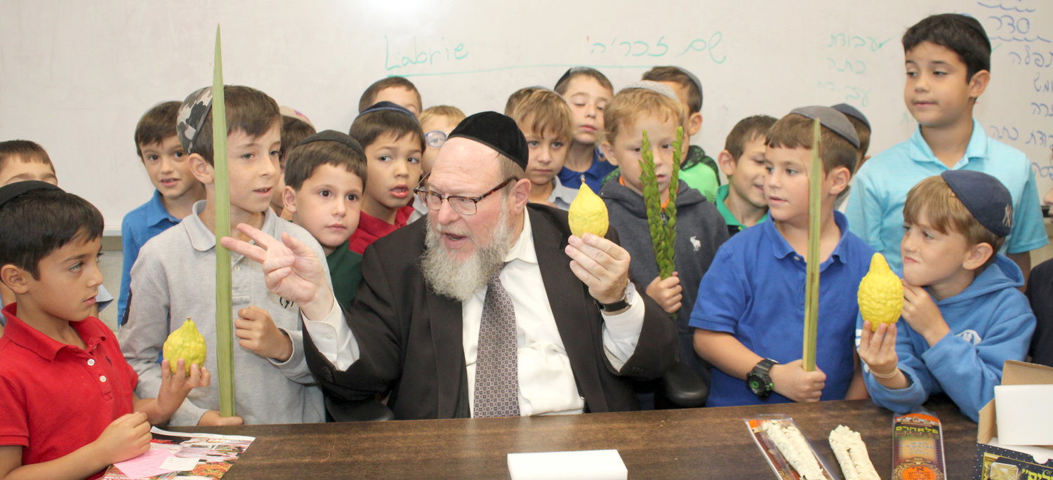 Rav Eliyahu Saldinger teaches his second grade talmidim at Yeshiva Darchei Torah in Far Rockaway about the lulav and esrog, important mitzvot attached to Sukkos, which begins Sunday night.