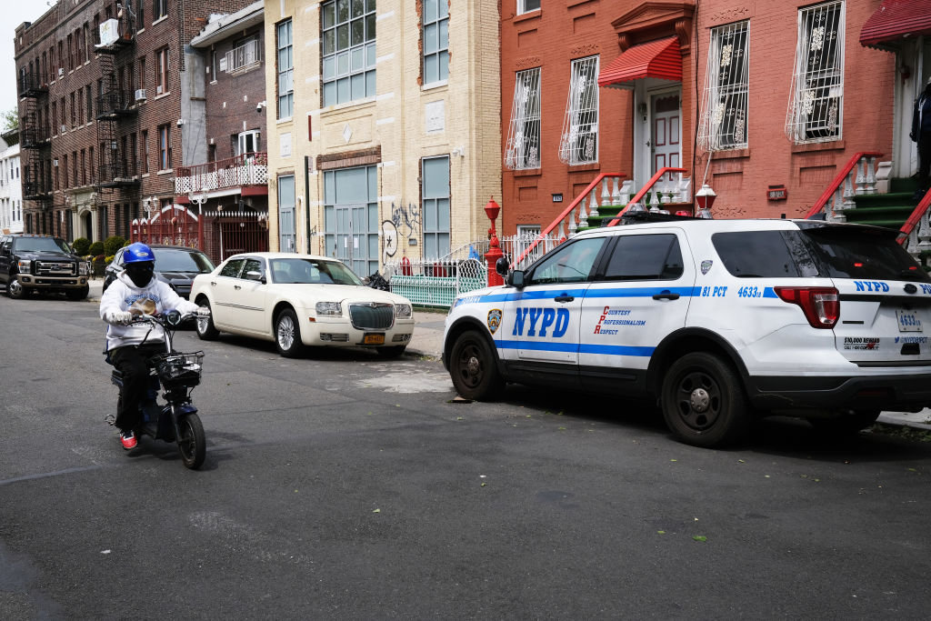 Police keep watch at a building used as a yeshiva in Brooklyn on May 19. Police broke up a session of about 60 students there.