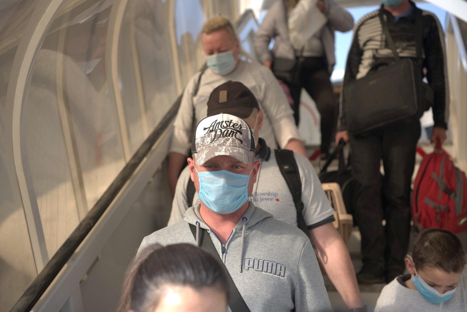 A group of new Jewish immigrants meant to arrive in Israel in March instead entered Ben-Gurion International Airport on May 20, 2020, due to delays as a result of the coronavirus.