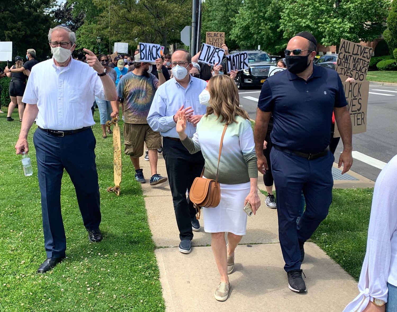 Marching at Andrew Parise Park in Cendarhurst on Sunday, Rabbi Kenneth Hain of Congregation Beth Sholom in Lawrence (left) and Lawrence Deputy Mayor Michael Fragin (right).