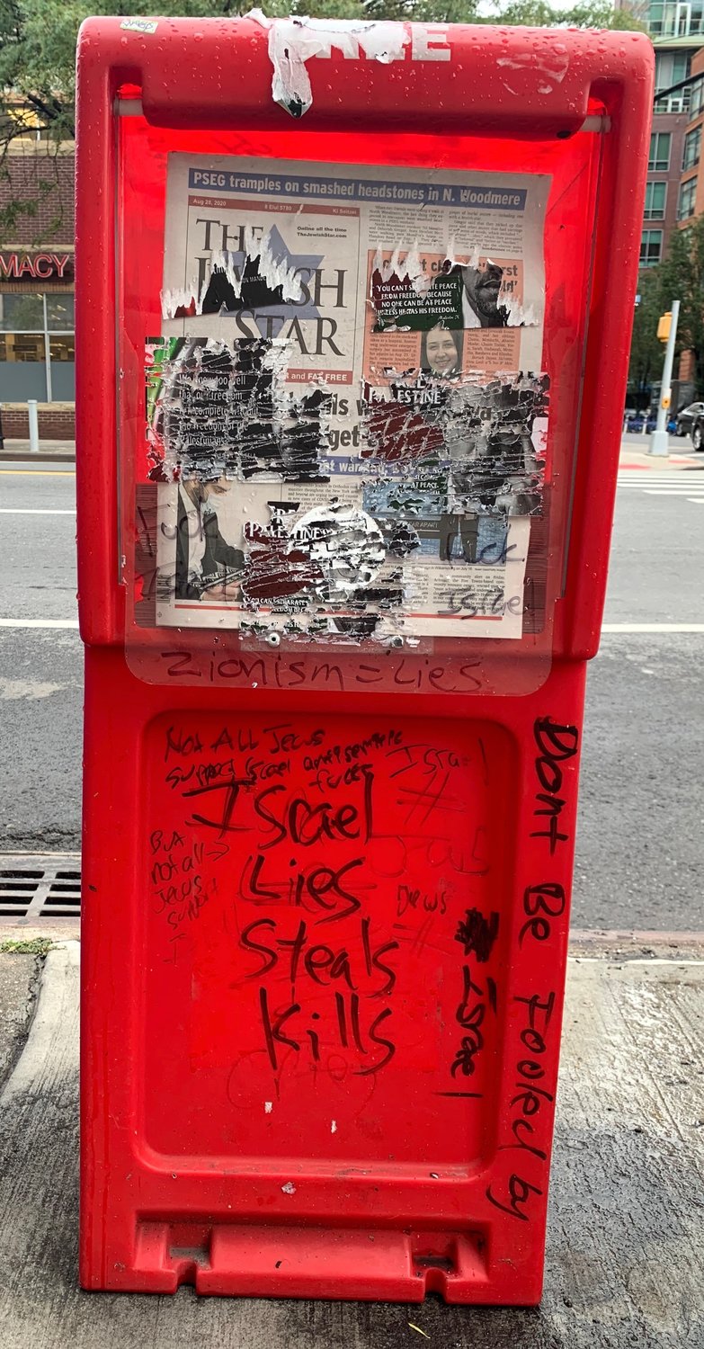 Two Jewish Star newsboxes in Downtown Brooklyn were vandalized with anti-Israel graffiti and plastered with stickers (removed before this photo was shot) attributing anti-Israel sentiments to Malcolm X and Nelson Mandela. The boxes are in well-lit heavily trafficked areas, outside Boro Hall and Trader Joes.